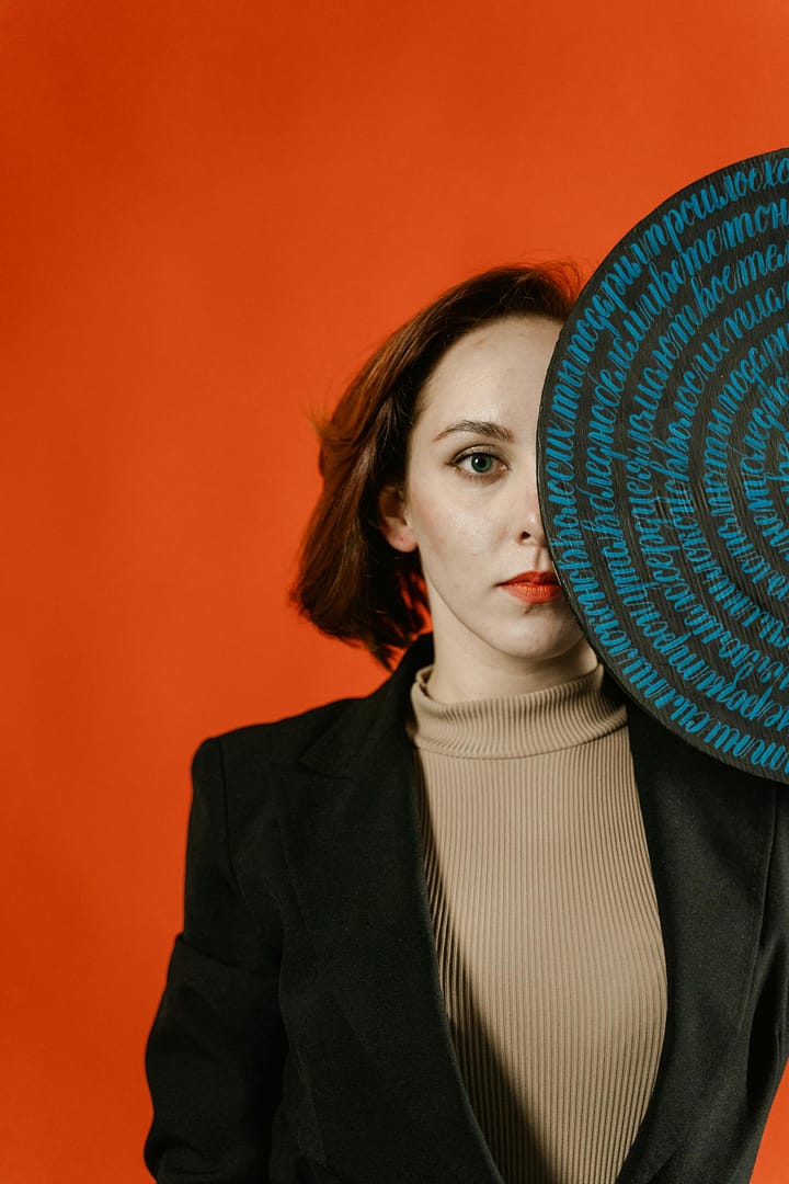 Woman in Black Blazer and White Turtleneck Shirt